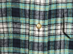 Celine green plaid flannel shirt featuring two flap pockets and a gold Arc de Triomphe button detail.