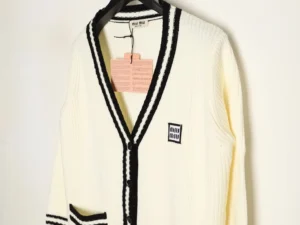 Miu Miu Logo Contrasting Sweater Cardigan in cream with black trim, featuring a V-neck design, pockets, and brand logo tag.