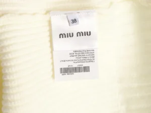 Miu Miu clothing label featuring size 38 and product details for the Miu Miu Logo Contrasting Sweater Cardigan.