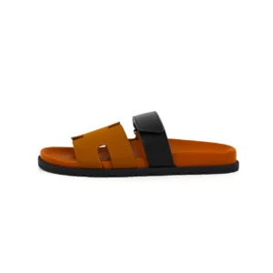 Hermes slippers in orange and black, featuring a flat design and open-toe style, highlighting luxury materials, available for pre-sale.
