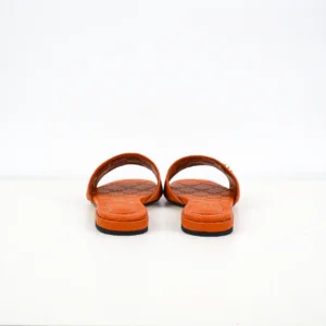 Gucci Double G women's slippers in orange sheepskin leather, showcasing iconic double-G logo and minimalist design, suitable for luxury footwear collection.