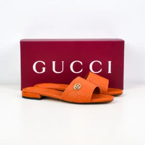 Gucci Double G women's slippers in orange sheepskin leather with iconic logo, displayed with branded packaging.