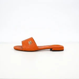 Gucci Double G women's slippers in orange sheepskin leather, featuring iconic double-G logo, stylish design for luxury footwear.