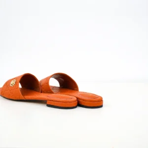 Gucci Double G women's slippers in orange sheepskin leather, featuring iconic double-G logo, showcasing luxury footwear design.