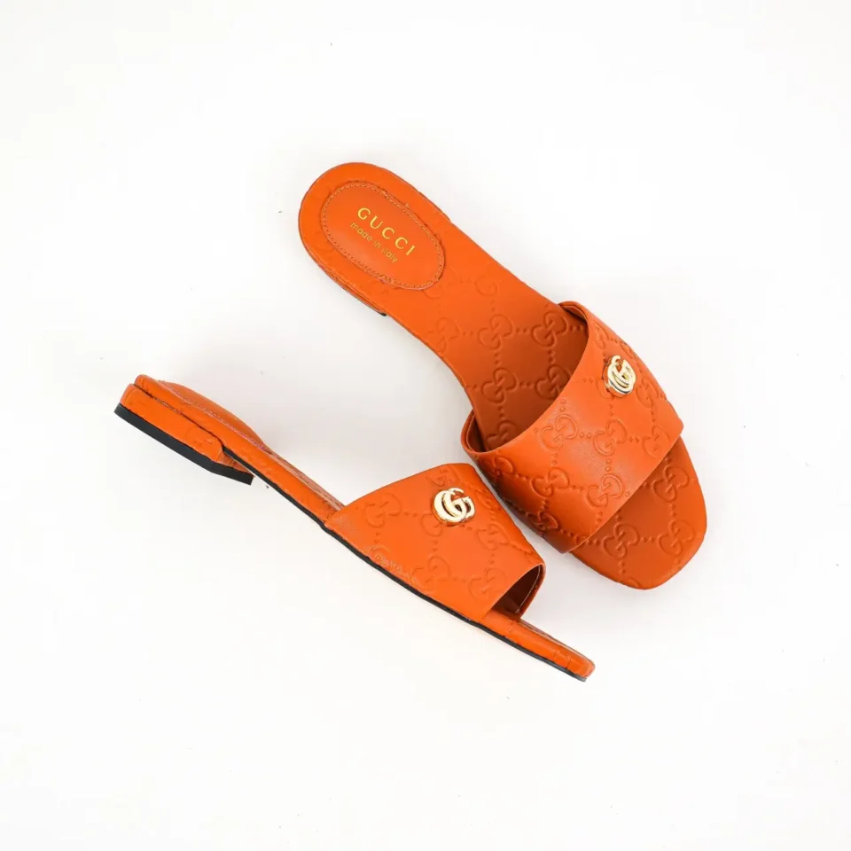 Gucci GG Marmont slides orange leather flat sandals with embossed logo and gold double G hardware