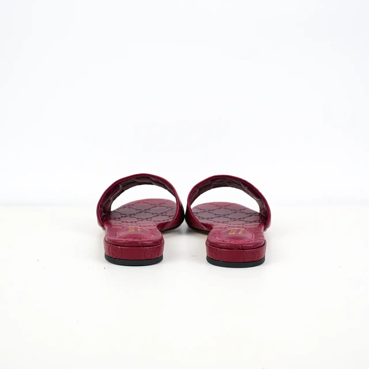 Gucci leather slide sandals dark red embossed leather flat open-toe slip-ons