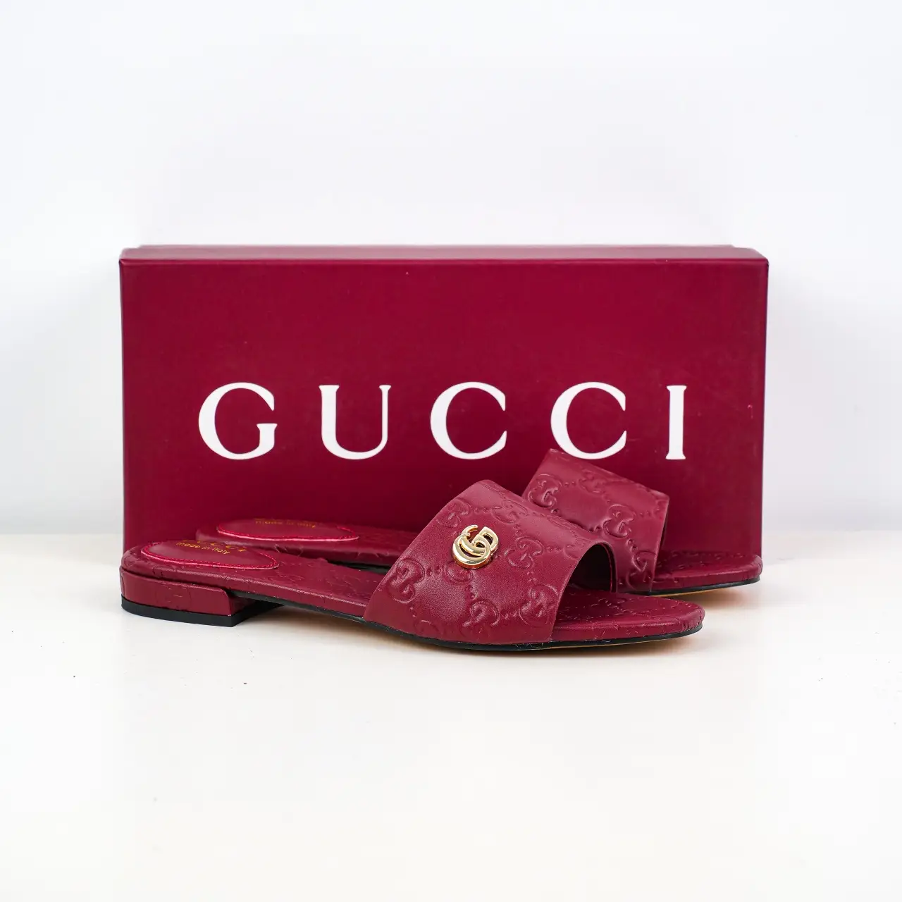 Gucci GG Slide Sandal red leather embossed floral pattern with gold interlocking G hardware flat slippers