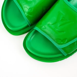 Green Louis Vuitton Miami Damier Round Head One Word Slippers featuring embossed logo and sleek design, showcasing luxury footwear style.