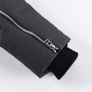 Close-up of Moose Knuckles Men's Original 3Q Shearling Trim Down Jacket sleeve featuring a zipper and ribbed cuff, showcasing high-quality materials and craftsmanship.