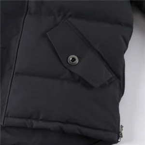 Close-up of Moose Knuckles Men's Original 3Q Shearling Trim Down Jacket sleeve with button detail and quilted texture, highlighting quality craftsmanship and design.