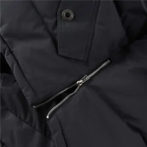 Close-up of Moose Knuckles Men's Original 3Q Shearling Trim Down Jacket featuring black fabric, zipper detail, and button closure, emphasizing high-quality craftsmanship and stylish design.