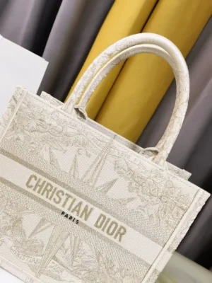 Dior Small Gold Dream Rêve d’Infini Pattern Tote handbag featuring embroidered design and CHRISTIAN DIOR Paris logo, showcasing luxury craftsmanship and style.