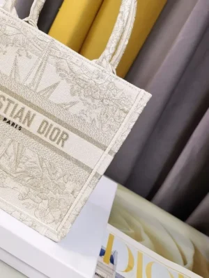 Dior Small Gold Dream Rêve d’Infini Pattern Tote showcasing intricate embroidery and CHRISTIAN DIOR Paris logo, elegant design on a neutral background.