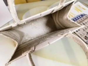 Interior view of Dior Small Gold Dream Rêve d’Infini Pattern Tote showcasing its elegant design and spacious compartment, highlighting the intricate details and luxurious craftsmanship.