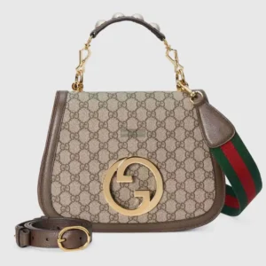 Gucci handbag featuring Double G interlocking design, beige and brown GG Supreme canvas, brown leather accents, and adjustable straps, showcasing luxury craftsmanship.