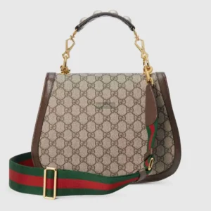 Gucci handbag featuring Double G interlocking design, beige and brown GG Supreme canvas, brown leather accents, and a detachable green and red striped canvas strap.