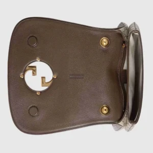 Gucci handbag interior featuring Double G interlocking design, brown leather, and gold hardware accents.