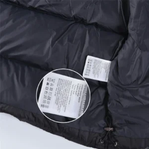 The image shows inside a black puffer jacket with visible care labels but does not match the specified product categories (watches, sneakers, bags, accessories) for alt text generation. Please provide an image of a watch, sneaker, bag, or accessory with brand and model details for accurate SEO-optimized alt text.