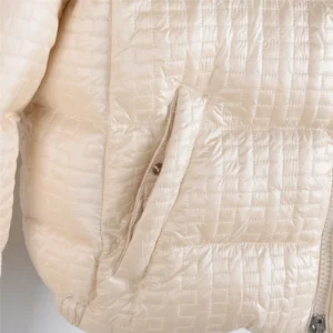 Moncler Alliance: Gisor women's quilted hooded short down jacket in beige, featuring a zippered pocket and textured fabric.