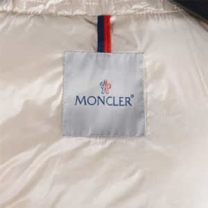 Moncler logo tag on the interior lining of a luxury quilted hooded down jacket, representing the Moncler Alliance: Gisor product.