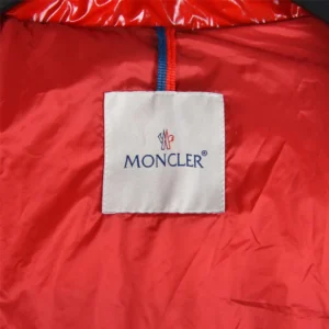 Moncler logo tag on red lining of jacket, highlighting premium quality and brand identity for Moncler Second Generation Small Waist with Black Details.