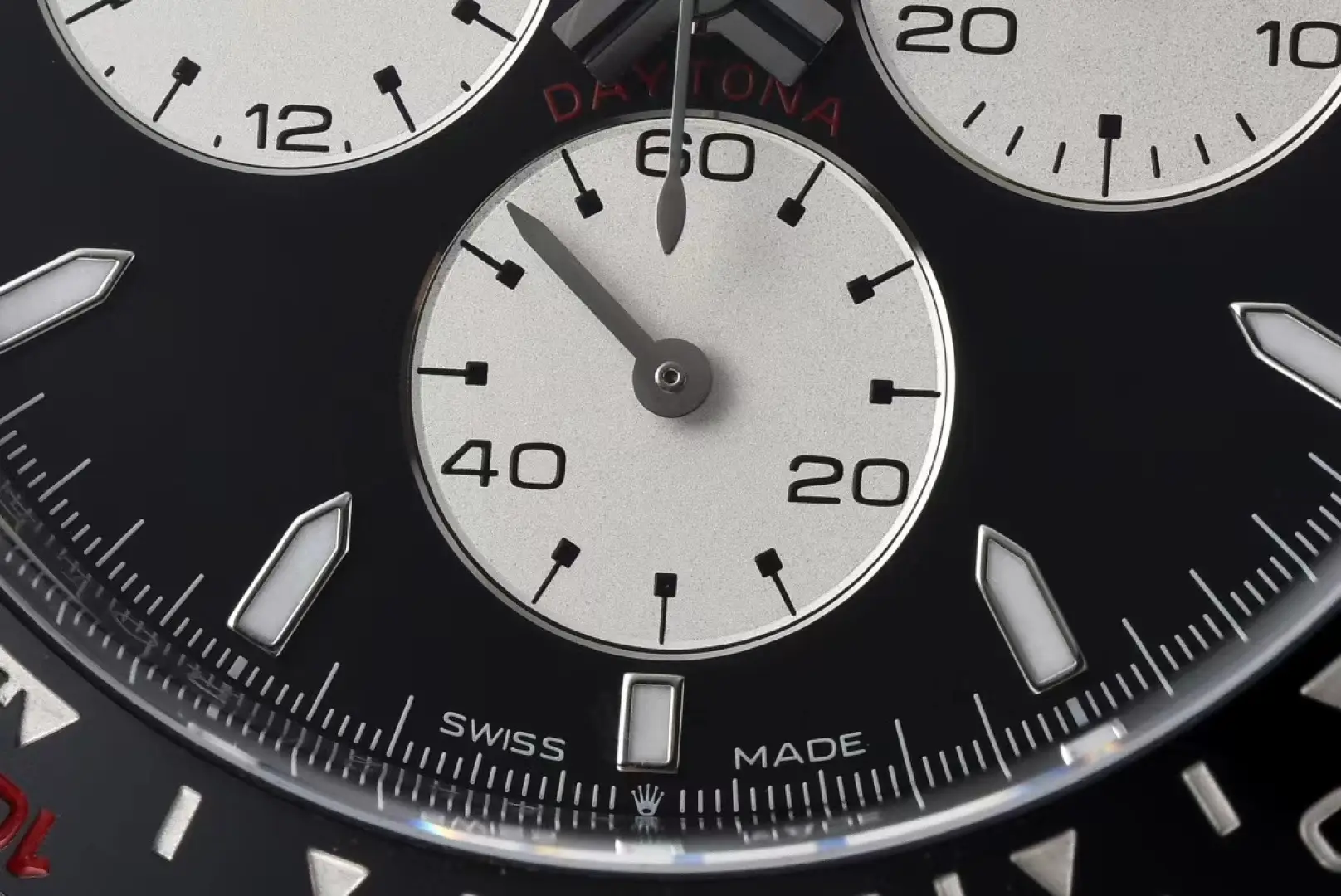 Rolex Daytona black dial ceramic bezel stainless steel watch close-up subdials and markings