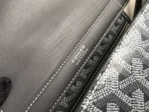 Goyard Rouette bag interior detail showcasing logo and contrasting fabric patterns, highlighting luxury craftsmanship and design.