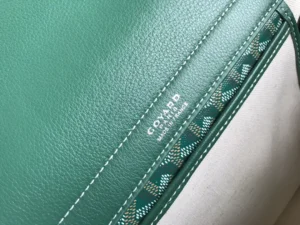 Goyard Rouette bag detail showcasing green leather texture and logo, highlighting craftsmanship and luxury materials.