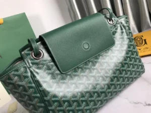 Goyard Rouette bag in green with a textured pattern and leather flap, showcasing luxury design and versatility for everyday use.