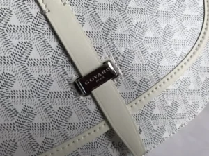 Goyard Belv é d è re Single Mailman Bag featuring a narrow buckle, signature logo, and textured fabric design, emphasizing luxury and minimalism.