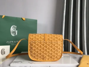 Goyard Belv é d è re Single Mailman Bag in yellow, featuring embossed design and adjustable shoulder strap, with branded packaging in the background.