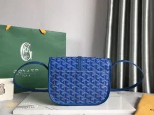 Goyard Belv é d è re Single Mailman Bag in blue, featuring a minimalist design with adjustable straps, displayed on a marble surface alongside Goyard packaging.