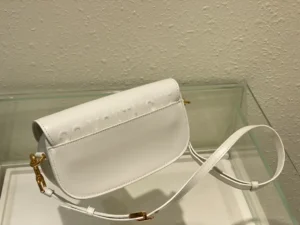 Dior Bobby East-West Bag in white leather with detachable shoulder strap, showcasing luxury design and elegant style.