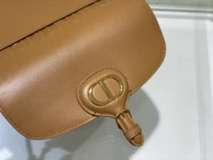 Dior Bobby East-West Bag in tan leather showcasing the signature logo clasp and sleek design, emphasizing luxury and versatility.
