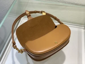 Dior Bobby East-West Bag displayed from above, showcasing its luxurious brown leather exterior, detachable shoulder strap, and spacious interior, emphasizing its stylish design and versatility.