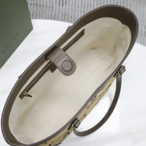 Interior view of a trendy business leather bag, showcasing the spacious beige lining and a zipper pocket, highlighting its luxurious design and functionality.