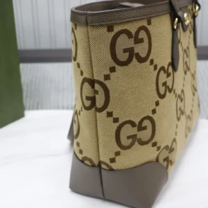 Trendy Gucci business leather bag featuring iconic GG monogram pattern, beige canvas with brown accents, showcasing side view and structural design.