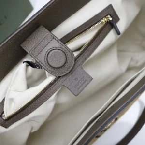 Interior view of a Gucci trendy business leather bag, featuring a zipper compartment and a beige lining, showcasing quality craftsmanship and design.