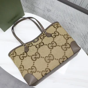 Trendy Gucci business leather tote bag featuring signature GG monogram design, brown leather accents, and spacious interior, ideal for stylish professionals.