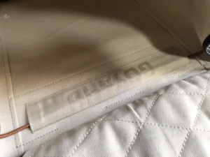 Goyard logo on the interior of a Goyard Alpin backpack, showcasing craftsmanship and brand identity.