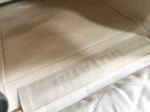 Cohana premium beige canvas pouch with stitched branding and leather detail on zipper pull