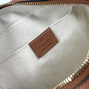 Gucci label inside apricot leather tote bag, showcasing premium quality and craftsmanship.