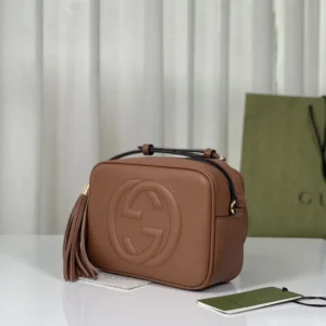 Gucci Apricot Leather Tote with logo detail and tassel, displayed on a white surface, emphasizing premium replica fashion.