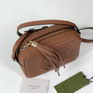 Gucci Apricot Leather Tote with tassel detail and brand tags, showcasing premium replica craftsmanship for online retail.