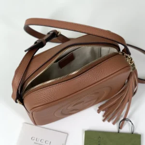 Gucci Apricot Leather Tote showcasing a brown textured exterior, zipper opening, interior lining, and tassel detail, with brand tags visible.