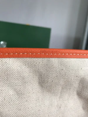 Hermès bag canvas interior orange leather trim detailed stitching made in France close-up