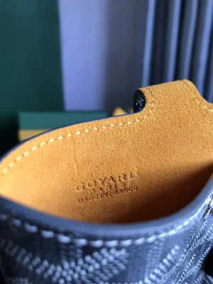 Goyard MontMartre GM bag interior showing embossed logo and yellow suede lining, emphasizing luxury and craftsmanship for versatile fashion use.