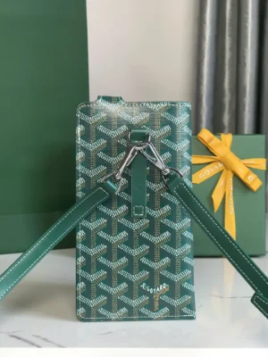 Goyard MontMartre GM Green bag with signature pattern, adjustable straps, and stylish design, presented alongside a gift box and decorative ribbon, emphasizing versatility and luxury.