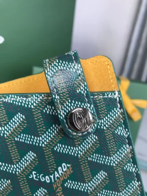 Goyard MontMartre GM Green bag detail featuring green and yellow patterned design, logo snap closure, and stylish craftsmanship, emphasizing luxury accessory for everyday use.
