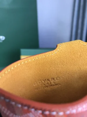 Interior view of Goyard MontMartre GM bag showcasing orange leather lining and embossed logo with "Goyard Paris Made in France."
